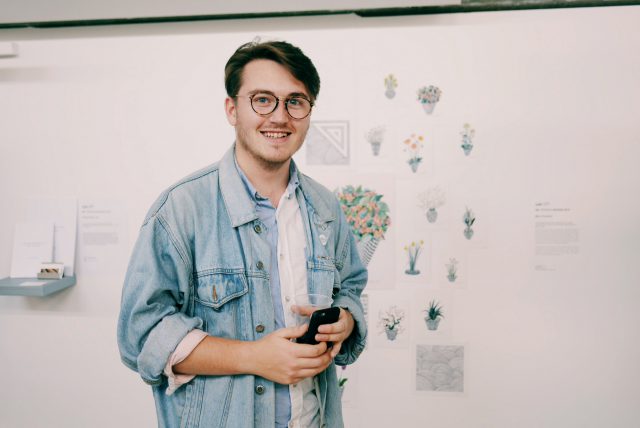 portrait of Andrew Illman holding a camera